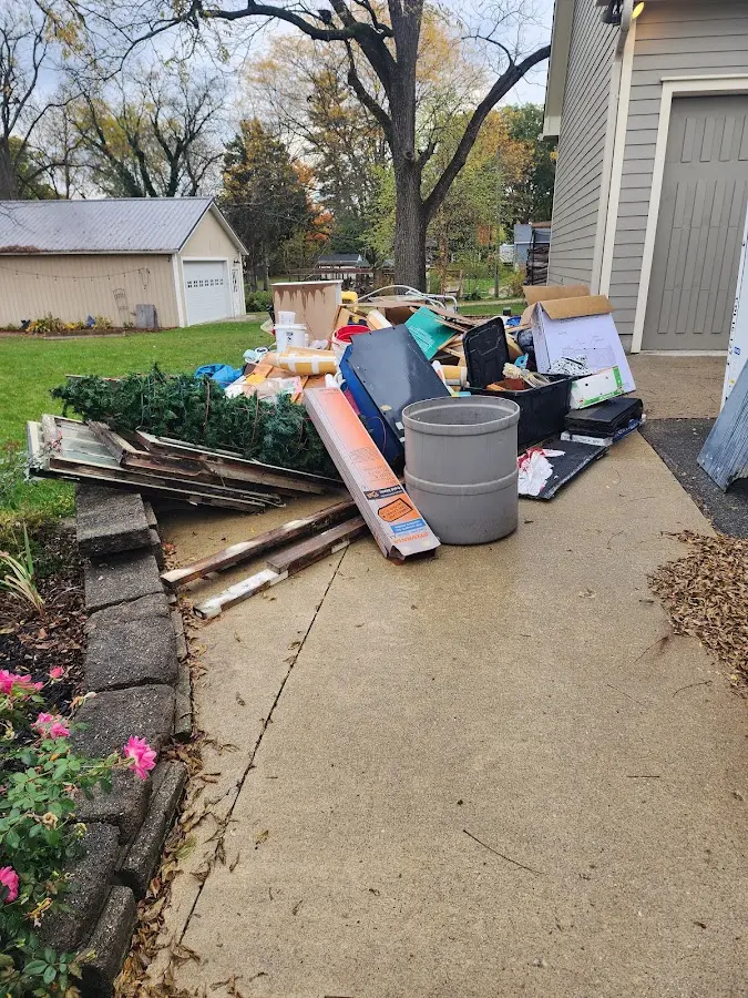 Dumpster being loaded with debris for 3 Yard Dumpster Rental in Belton
